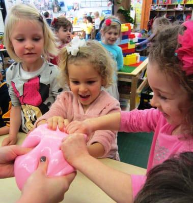 Gooey, Goopy, and Great!  The students squeeze their hands into a fresh and homemade batch of GaK!