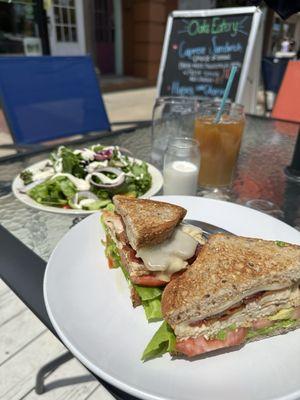 Turkey Swiss Sandwich on multi-grain (add bacon), salad & iced coffee.