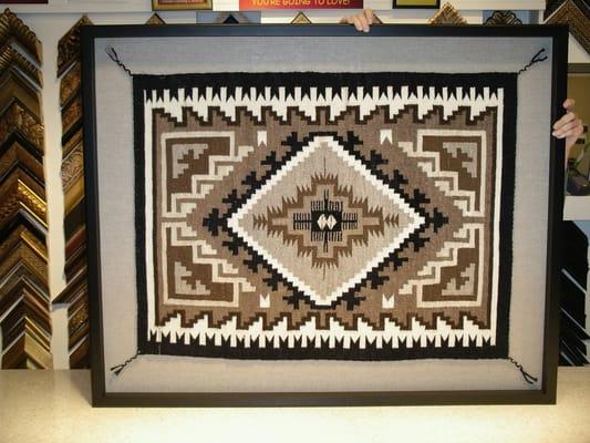 Southwest Navajo blanket floated on linen and encased in wood shadowbox frame.