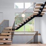 Floating single stringer stair with vertical spindles and wood treads