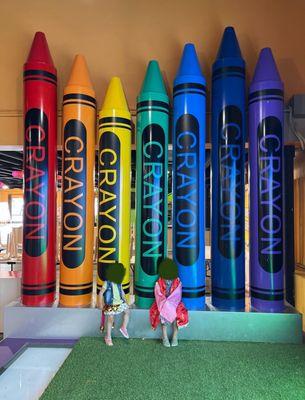 Huge crayons photo op while playing dress up on a stage