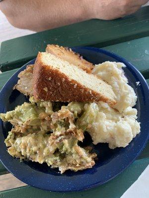 Tenderloin dinner with broccoli casserole, mashed potatoes, and cornbread.