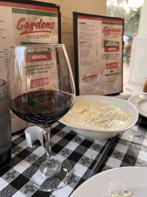 Wine and side of Alfredo with capellini