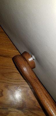 Rocking chair handle and round piece of wood slides back and forth