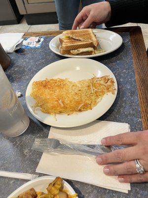 Bacon egg and cheese sandwich with hash browns