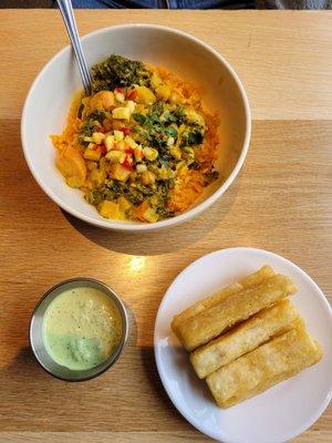 The curry bowl with a side of fried Yucca.