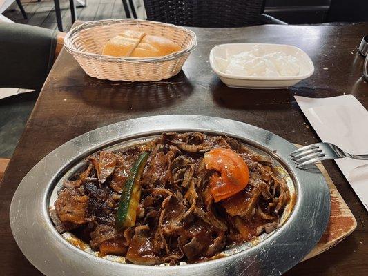 Iskender Kebab. Gyro plate with tomato sauce and yogurt.