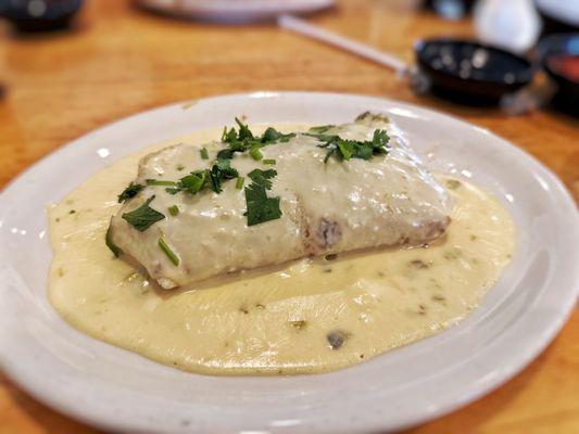 Burrito de Carnitas smothered with an excellent cheesy sauce.