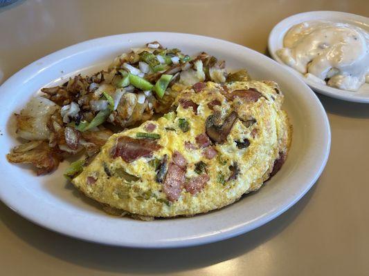 French Omelette with country potatoes and biscuit and gravy.