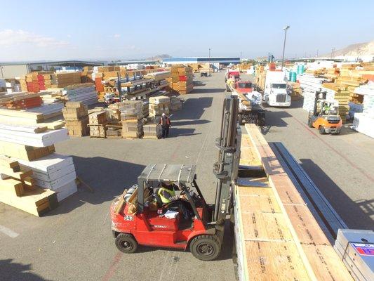 Forklift ready to lift load of lumber to be loaded on to customer's truck.