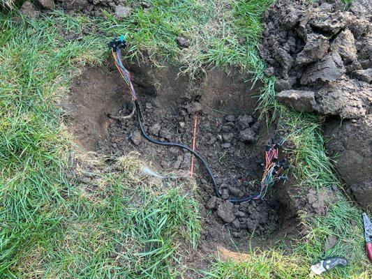 Mediacom cable in orange; damaged electrical wiring for sprinkler system (left/right).