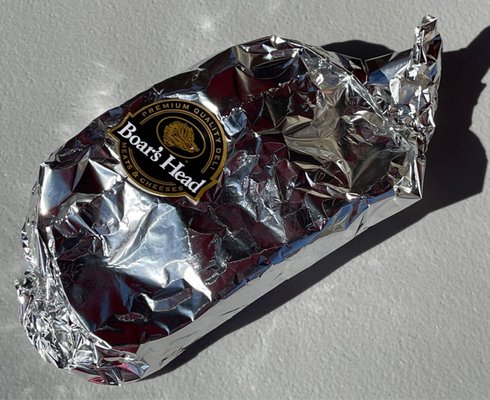 Breakfast sandwich wrapped in wax and then in foil