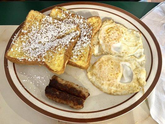 French toast, sausage links, and over-medium eggs.