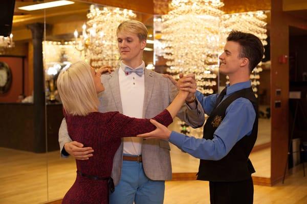 Dance With me instructor teaching couple their wedding dance routine.