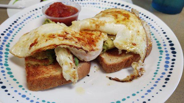 Avocado and egg on toast with salsa on the side. Good ingredients, very good taste together.