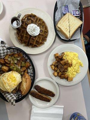 Pumpkin waffle, breakfast sandwich and chorizo sausage with eggs and potatoes