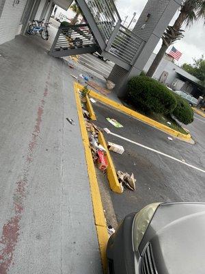 The trash cans in the parking lot.