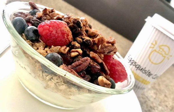 Very berry energy bowl with granola, pecans, berries, raisins, craisins, cinnamon  piled on top of yogurt.