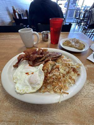 This is the combo breakfast you get two eggs hashbrowns ham slice two sausage patties, three pieces of bacon and French toast.