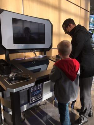 Casadaro showing my son some of the features on their build your own truck display!