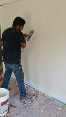 Skim-coating and texturing walls