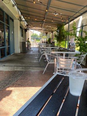 Outdoor seating area under shade. They also have heaters for those chilly days/nights.