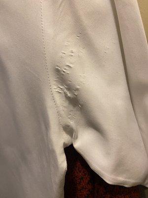 Arm pit area of a white bottom up dress shirt