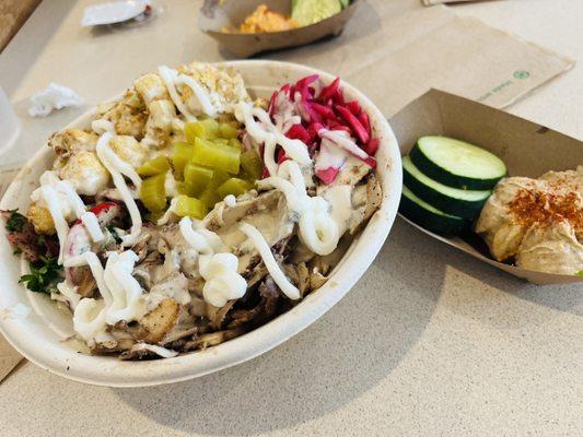 Chicken Shawarma Bowl with a side of black olive hummus and cucumbers. Delightful!