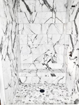 Beautiful marble shower with a bench