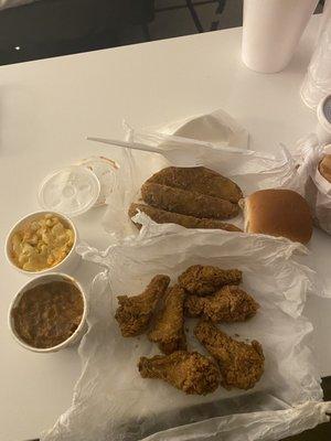 Fried chicken, macaroni, yams, potato wedges, roll, pink lemonade