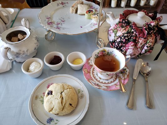 cranberry scone with cream, strawberry jam and lemon curd