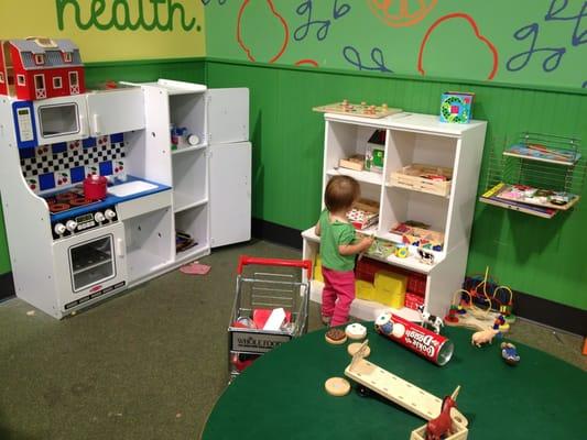 Small play area full of Melissa and Doug toys. Kinda shabby already, but still toddler approved.