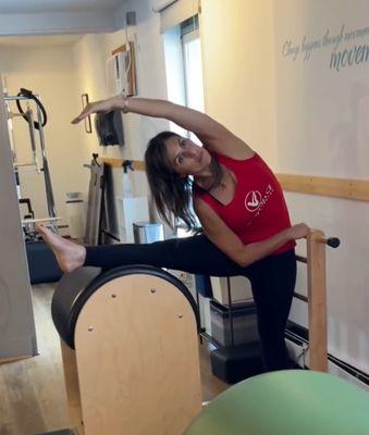 Sandra doing ballet stretches on Ladder Barrel