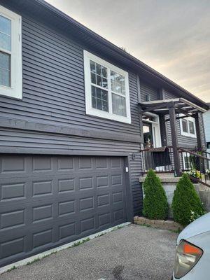 Primed and painted exterior job on a home and garage door.