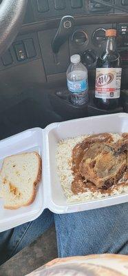 Rice with brown gravy one pork chop in a piece of white bread and an A&W zero sugar. Fuel Island bld. Hot deli