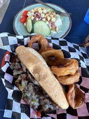 Philly with onion rings and side salad.