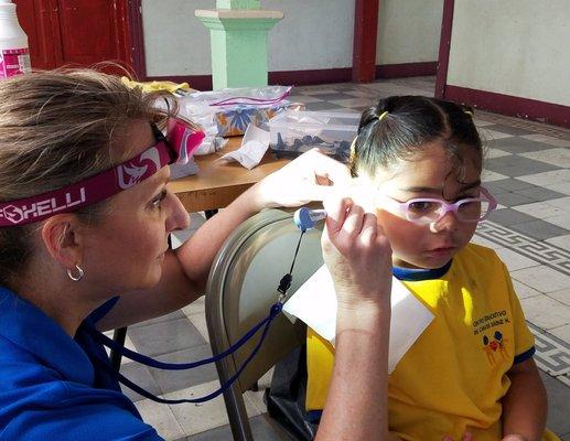 Dr. Rudden providing hearing care on a mission in St. Lucia.