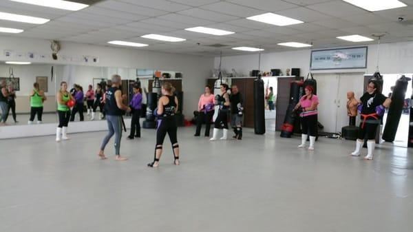 Partnering up in class to learn kicking and blocking drills!