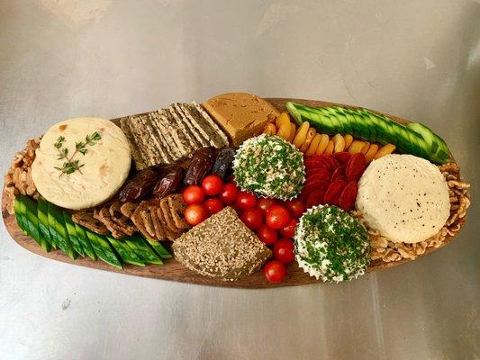 Vegan cheese board. From left: Camembert w/dried apricots, smoked cheddar, truffled camembert, herbed chevre balls, pumpkin/sunflower seed