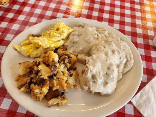 Sausage gravy and biscuits with scrambled eggs and fried potatoes.