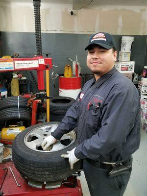 Edgar installing a new tire.