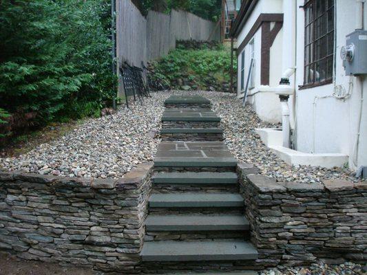 Natural stone walls and steps with bluestone treads.