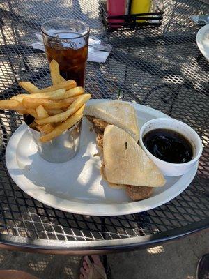 Brisket sandwich with au jus and fries.