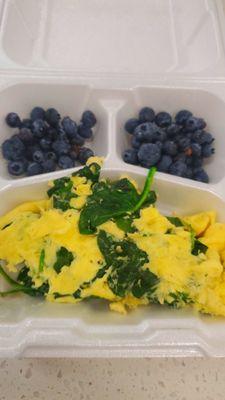 Two eggs with saute spinage and blueberries