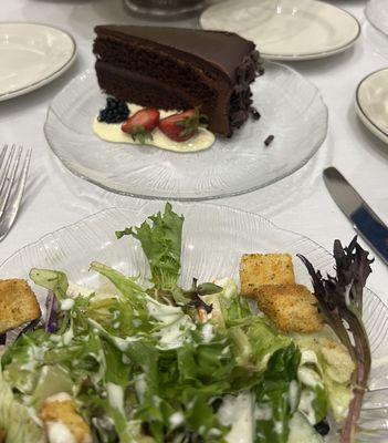 Side salad and cake were on the table.