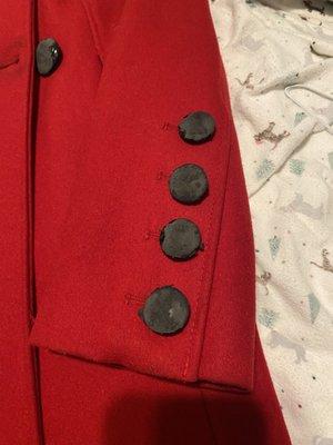 Melted buttons with flecks of melted material on the wool