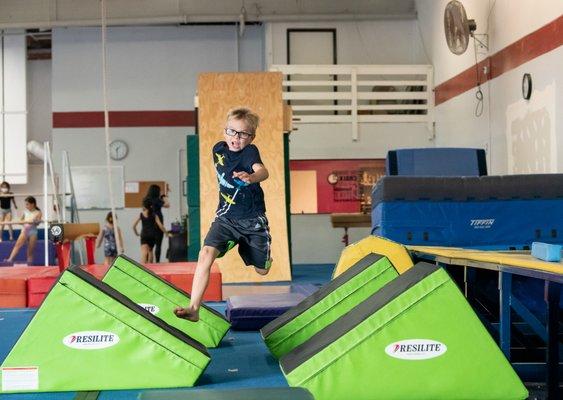 Boy crosses quadruple steps in obstacle course