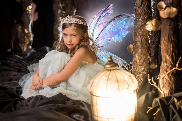 Sara in her fairy wings. Love the soft glow behind her.