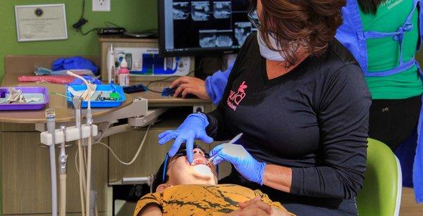 Dr. Carlen Blume performing an examination at Blume Pediatric Dentistry