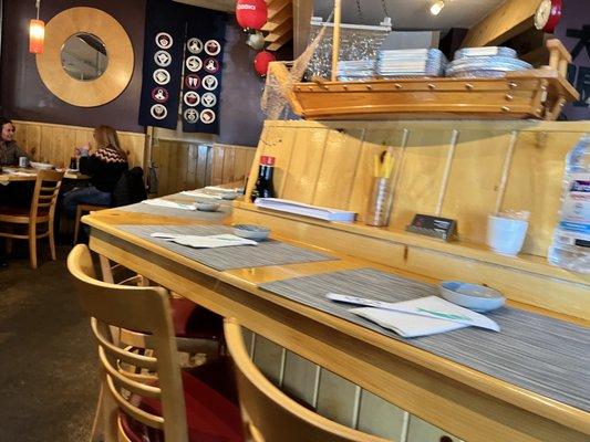 Sushi counter and tables in background